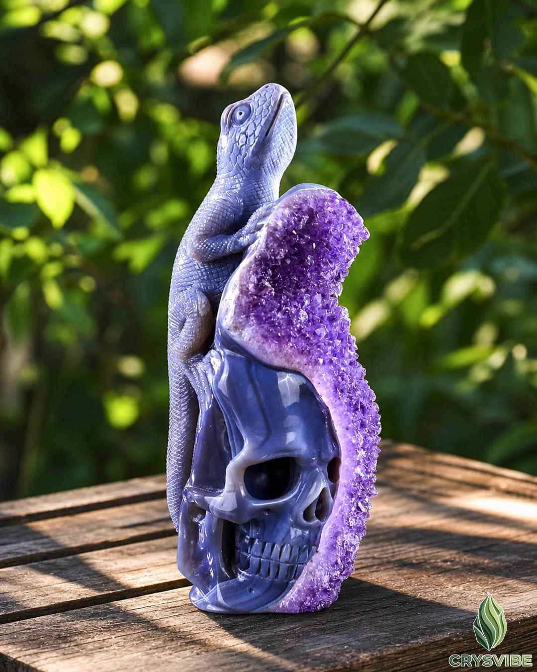 Gemstone human skull carving with animal figure on top